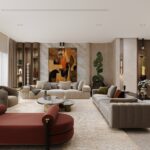 Modern formal living room with beige sofas, red accent chair, and abstract art.