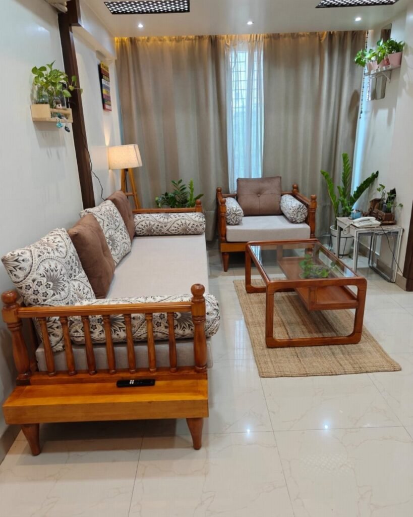 Wooden sofa and armchair with a glass coffee table in a small room