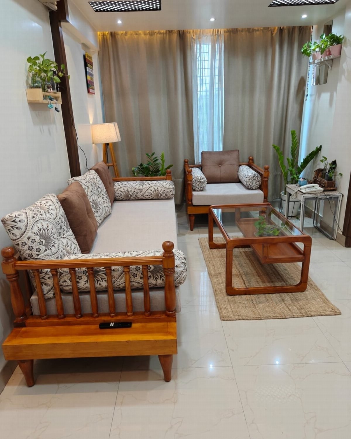 Wooden sofa and armchair with a glass coffee table in a small room
