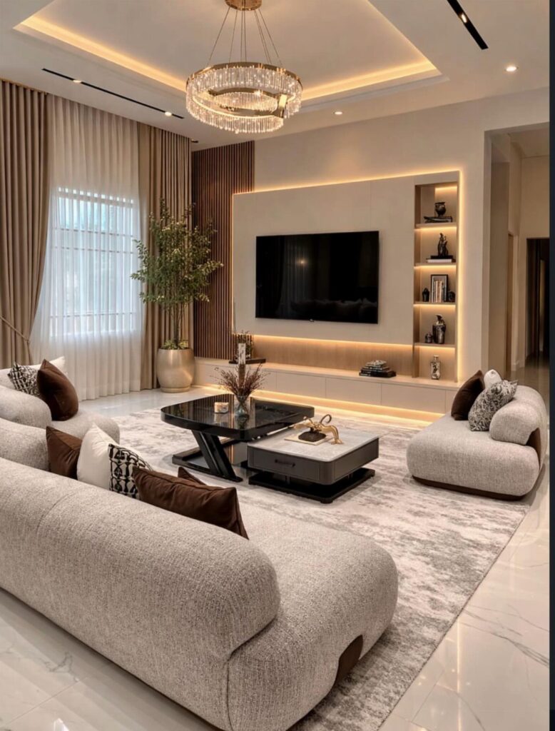 Modern living room with a large light grey curved sectional sofa and black coffee table.