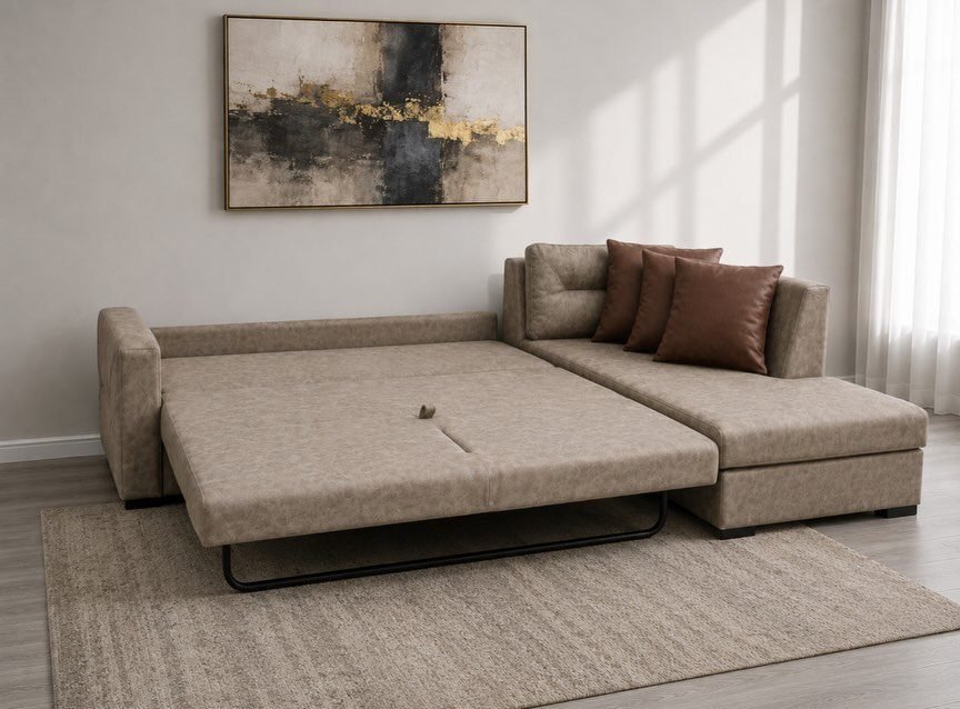 Beige sectional sofa with a pull-out bed extended in a bright living room.