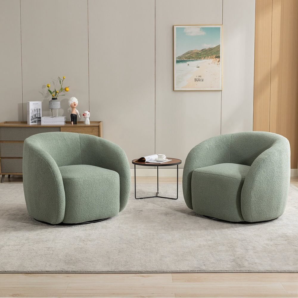 Two rounded light green accent chairs facing each other with a small coffee table.